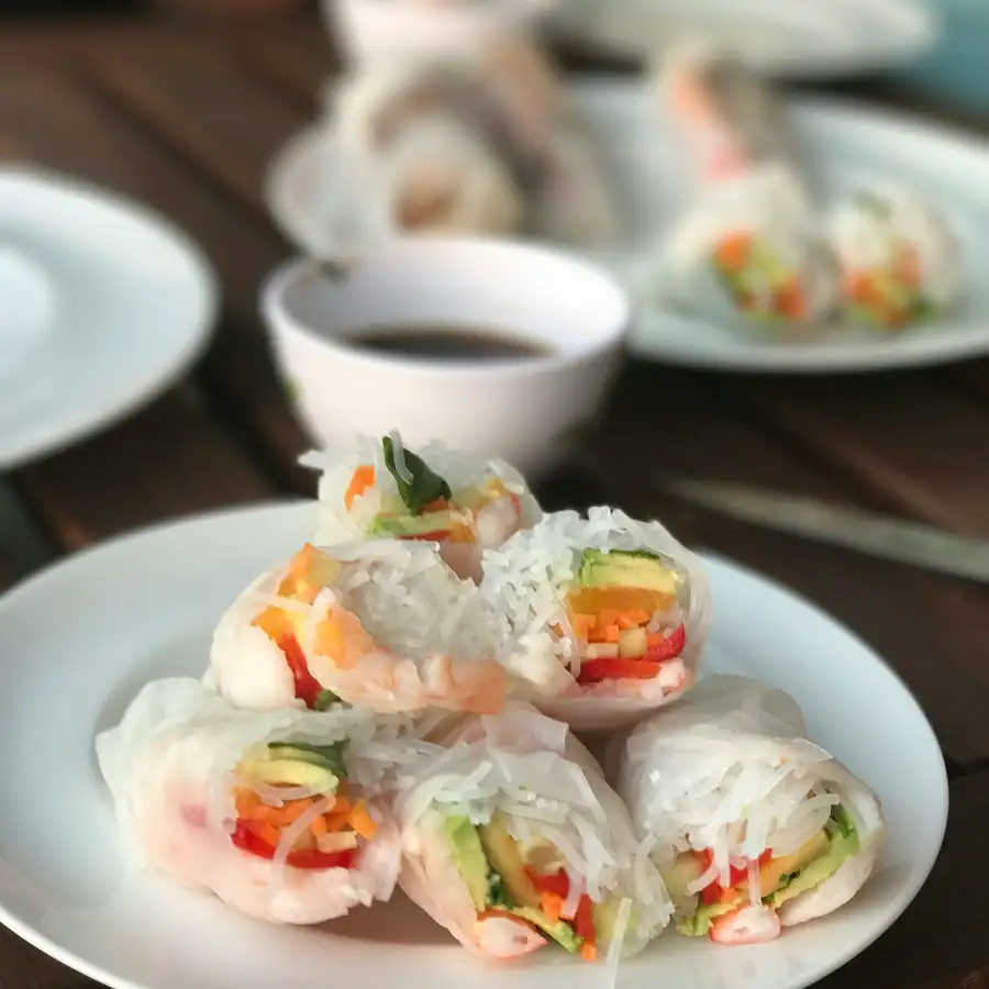Fresh rice-paper rolls filled with shrimp and herbs, with a small bowl of dipping sauce