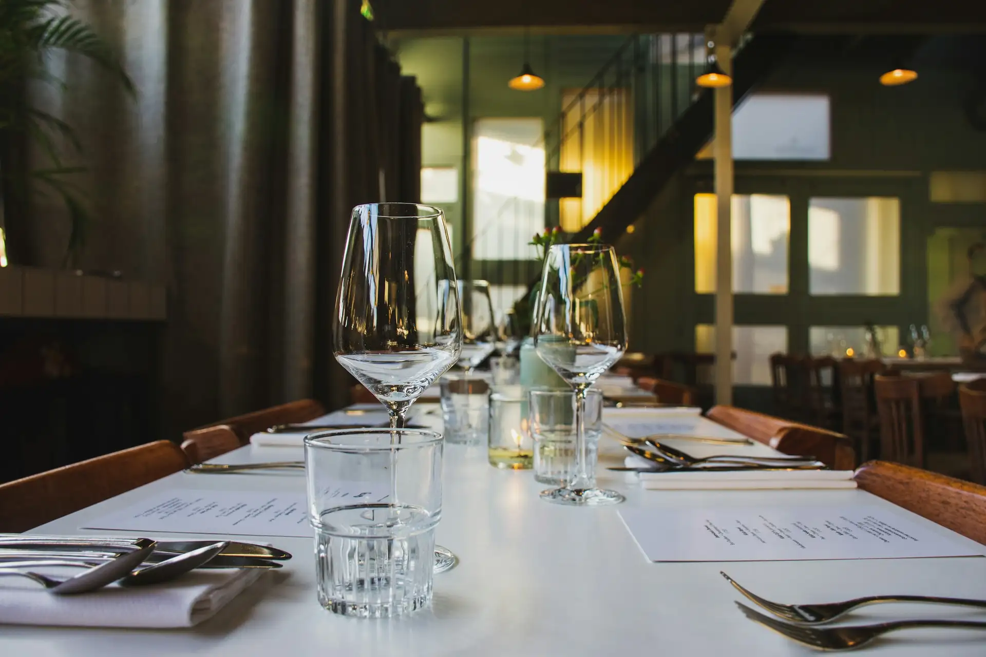 The long table in the back room, set with glasses for dinner